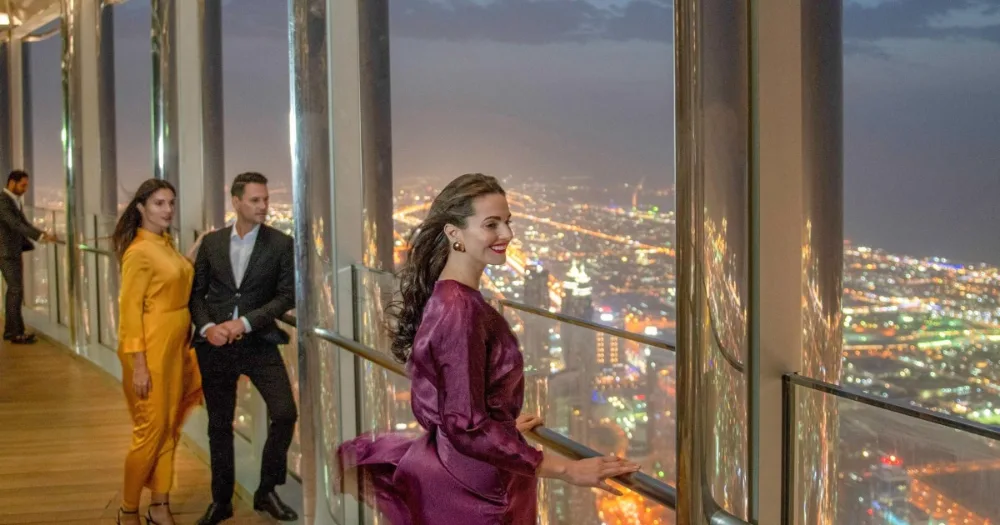 Guest using a telescope at Burj Khalifa At The Top during the day