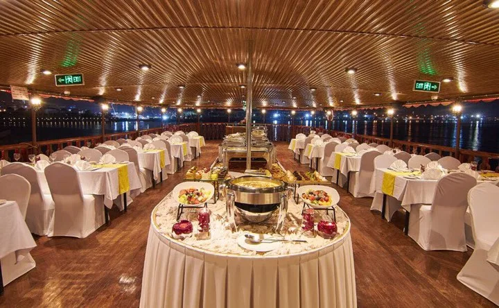 Onboard buffet dining hall set with white linens aboard the dhow